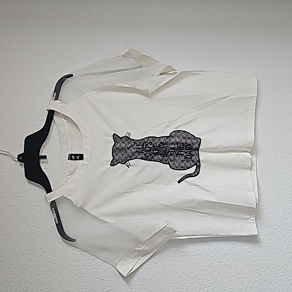 White top with cat on the front. Clear sleeves. Size S